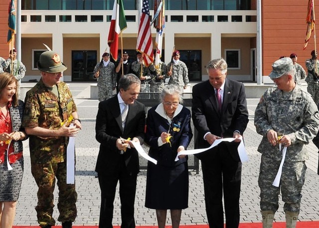 Paola Del Din, center, Italian Gold Medal for Valor recipient and sister of Gold Medal for Valor (posthumous) recipient 1st. Lt. Renato Del Din for whom Caserma Del Din is named, cuts a ribbon with U.S. Ambassador to Italy David Thorne, (right)....