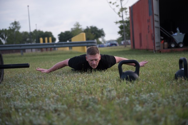 The 13th Expeditionary Sustainment Command’s Commanding General, Brig. Gen. Darren L. Werner, performs repetitions of the hand-release push-up during physical readiness training April 27.  Maintaining physical readiness is crucial during these unprecedented times, and incorporating the new ACFT requirements is something leaders stress the importance of with their Soldiers. (U.S. Army photo by Sgt. 1st Class Kelvin Ringold)