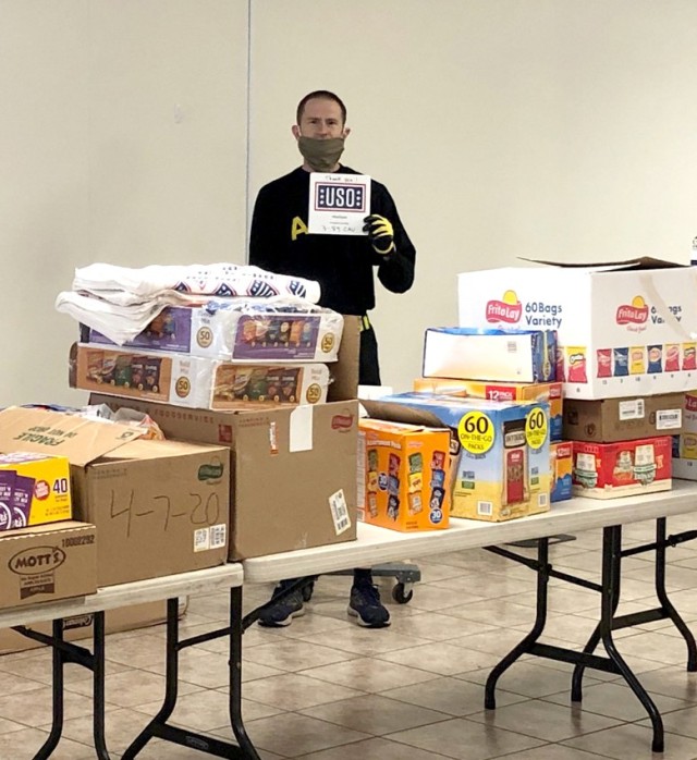 Chap. (Capt.) Luke Basler, 3rd Squadron, 89th Cavarly Regiment, 3rd Brigade Combat Team, 10th Mountain Division, displays food goods donated by USO and used to establish a food bank for Soldkers needing assistance in the wake of the COVID-19...
