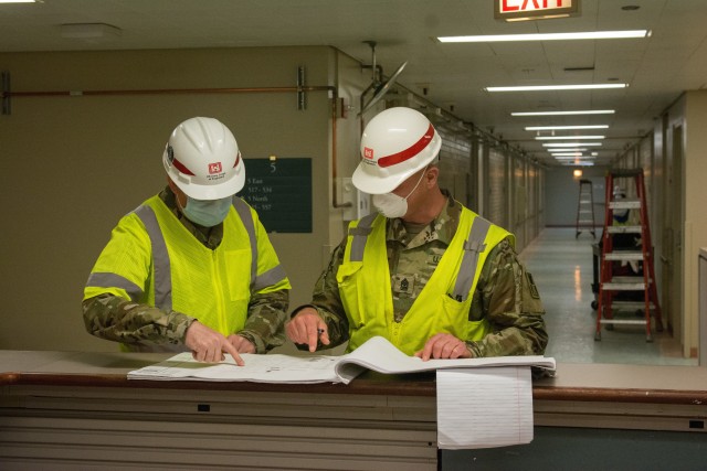 Left, Sgt. Maj. John Nelson. Nelson, a U.S. Army Reserve Soldier from the 416th Theater Command supporting U.S. Army Corps of Engineers project to rehabilitate Westlake Hospital in Melrose, Ill. into an alternate care facility (ACF) during the COVID-19 pandemic, reviews plans and drawings with Sgt. Maj. Steven Lotz from the 86th training division, as they provide quality control to the project, April 23, 2020 (U.S. Army photo by Sgt. 1st Class Jason Proseus/416th TEC).