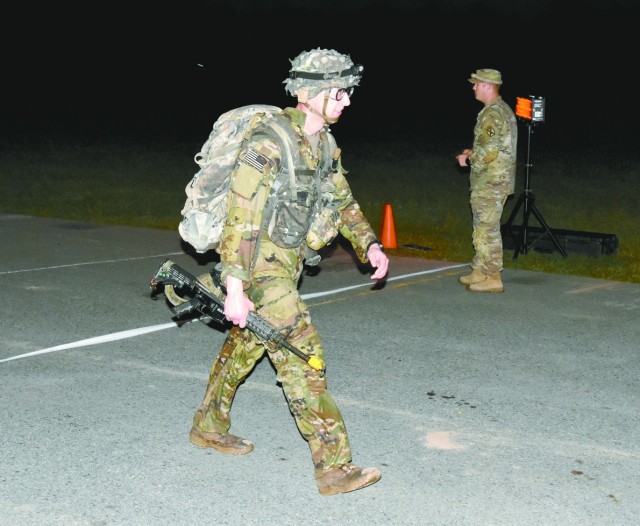 First Lt. Preston Bentley, Alpha Company, 2nd Battalion, 4th Infantry Regiment, 3rd Brigade Combat Team, 10th Mountain Division, is the first Soldier to cross the finish line of the 12-mile foot march, the final event in the Expert Infantryman’s...