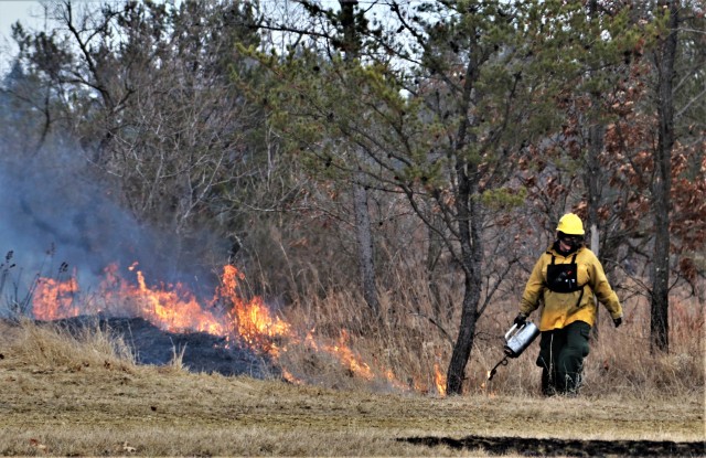 A Fort McCoy, Wis., prescribed burn team member oversees a prescribed burn March 16, 2020, along the railroad tracks on South Post at the installation. The post prescribed burn team includes personnel with the Fort McCoy Directorate of Emergency...