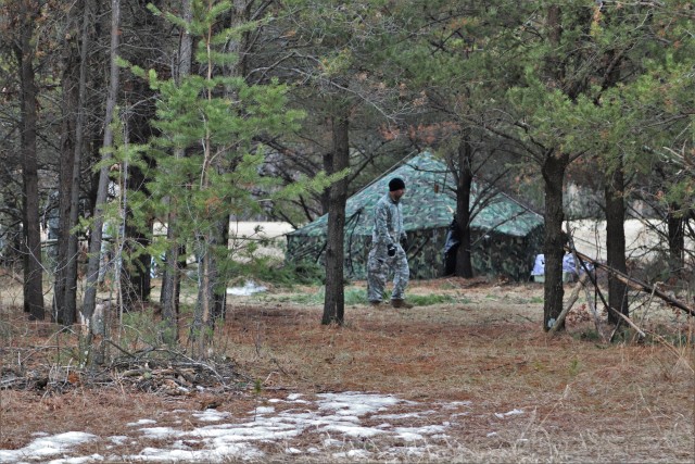 A student in Cold-Weather Operations Course (CWOC) Class 20-05 helps set up a bivouc area March 16, 2020, that includes an Arctic 10-person tent during training on North Post at Fort McCoy, Wis. CWOC students are trained on a variety of...