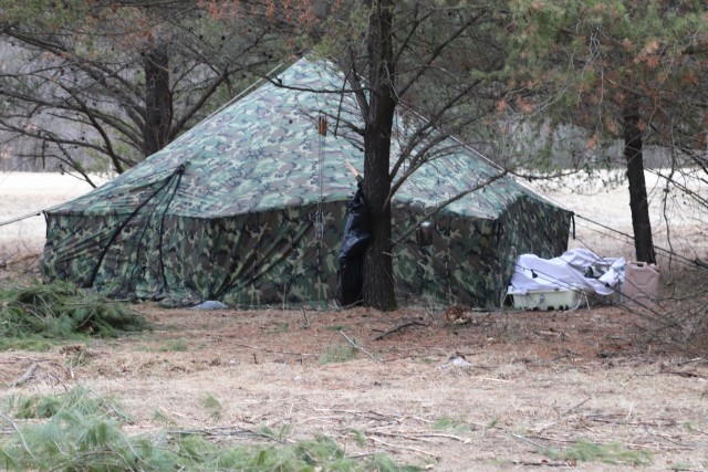 A raised Arctic 10-person tent is shown as students in Cold-Weather Operations Course (CWOC) Class 20-05 prepare to set up a bivouac area during training March 16, 2020, on a North Post training area at Fort McCoy, Wis. CWOC students are trained...