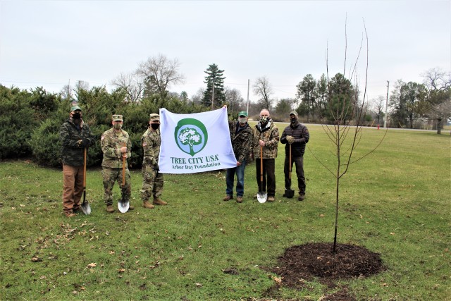 Garrison staff members, all practicing protective measures, stand with the post’s newest Tree City USA flag in front of a newly planted tree during the installation’s 2020 Arbor Day observance April 24, 2020, at Fort McCoy, Wis. For the...