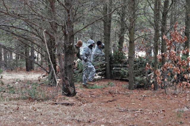 Students in Cold-Weather Operations Course (CWOC) Class 20-05 set up a bivouc area that includes an Arctic 10-person tent at a bivouac area during training March 16, 2020, on North Post at Fort McCoy, Wis. CWOC students are trained on a variety of...