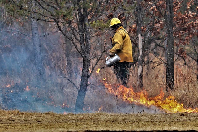 A Fort McCoy, Wis., prescribed burn team member oversees a prescribed burn March 16, 2020, along the railroad tracks on South Post at the installation. The post prescribed burn team includes personnel with the Fort McCoy Directorate of Emergency...