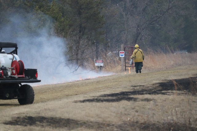 A Fort McCoy, Wis., prescribed burn team member oversees a prescribed burn March 16, 2020, along the railroad tracks on South Post at the installation. The post prescribed burn team includes personnel with the Fort McCoy Directorate of Emergency...