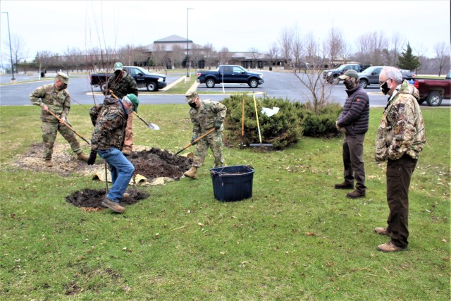 Garrison staff members, all practicing social distancing and other protective measures, plant a tree during the installation’s 2020 Arbor Day observance April 24, 2020, at Fort McCoy, Wis. For the ceremony held in front of McCoy’s Community...