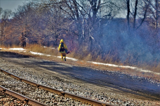 A Fort McCoy, Wis., prescribed burn team member oversees a prescribed burn March 4, 2020, along the railroad tracks on South Post at the installation. The post prescribed burn team includes personnel with the Fort McCoy Directorate of Emergency...