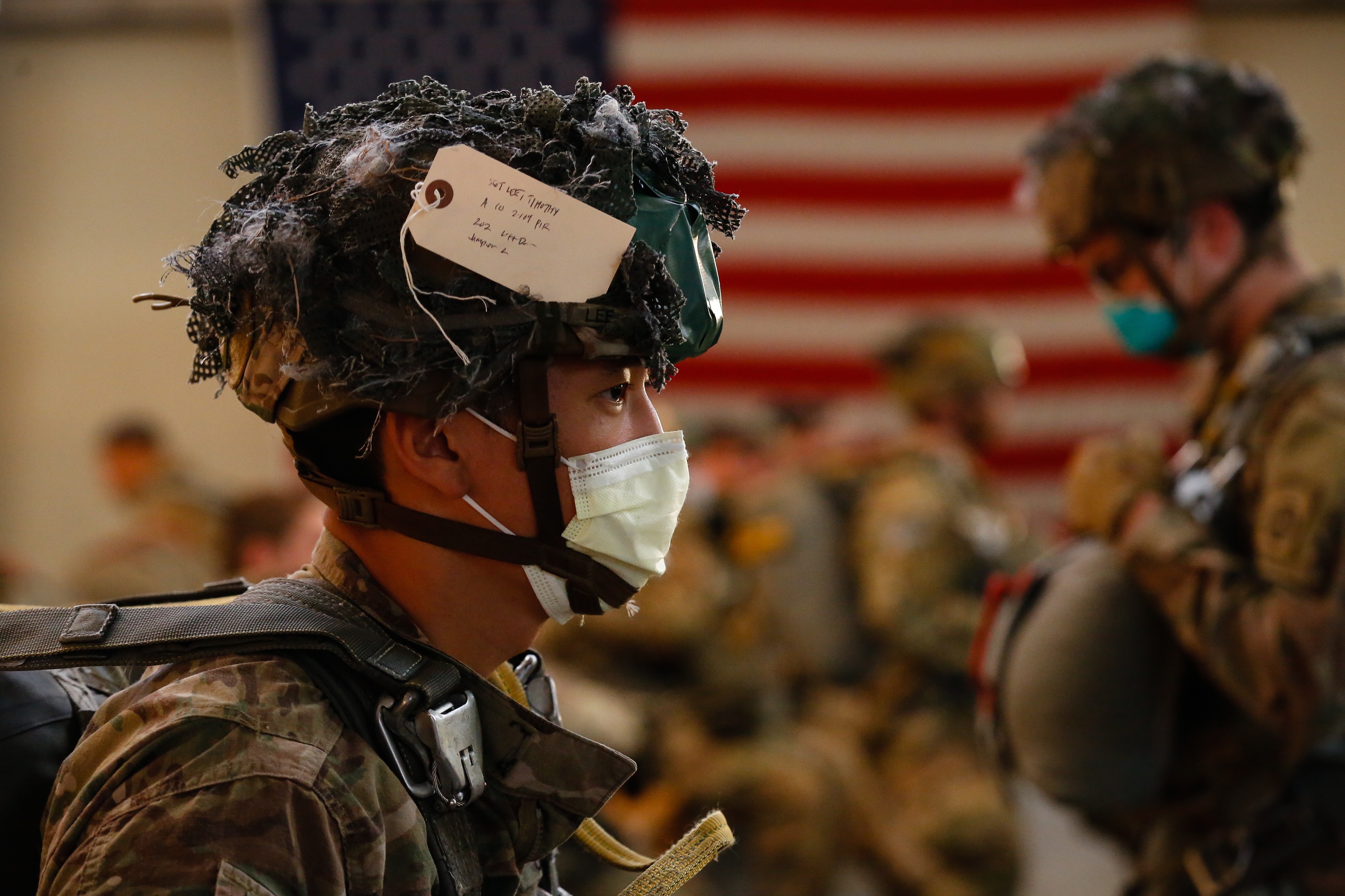 Sgt. Timothy Lee, a Paratrooper with the 1st Brigade Combat Team, 82nd Airborne Division, prepares for a Airborne Operation at Fort Bragg, N.C., on May 7. The airborne operation marks the 82nd Airborne Division’s return to limited training operations while following health and safety guidelines to prevent the spread of the novel coronavirus.  Paratroopers were required to wear masks while in close proximity to each other and Jumpmasters wore masks while conducting inspections in the passenger terminal.
