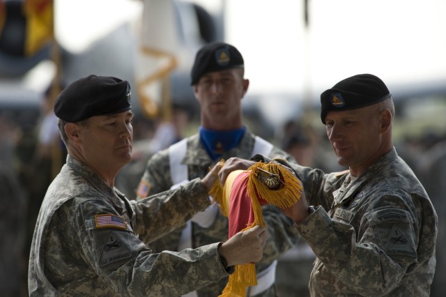 U.S. Army Maj. Gen. Terry A. Wolff (left), 1st Armored Division commander, and Command Sgt. Maj. William Johnson (right) case the division colors at a ceremony on Wiesbaden Army Airfield, Germany, May 13, 2011.  The event ended the division's...