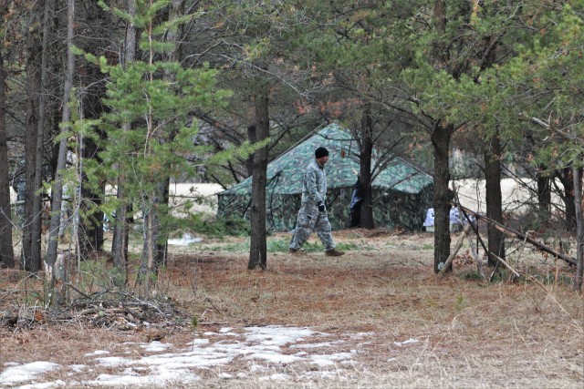 A student in Cold-Weather Operations Course (CWOC) Class 20-05 helps set up a bivouc area March 16, 2020, that includes an Arctic 10-person tent during training on North Post at Fort McCoy, Wis. CWOC students are trained on a variety of...