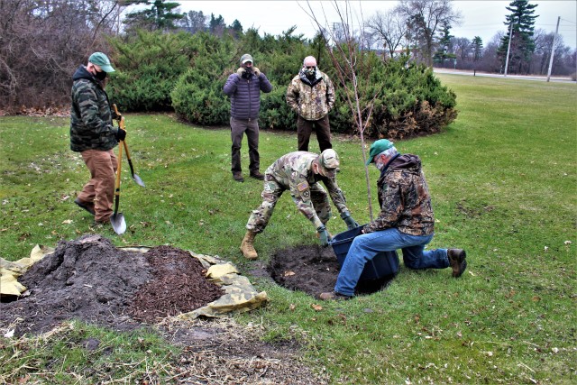 Garrison staff members, all practicing social distancing and other protective measures, plant a tree during the installation’s 2020 Arbor Day observance April 24, 2020, at Fort McCoy, Wis. For the ceremony held in front of McCoy’s Community...