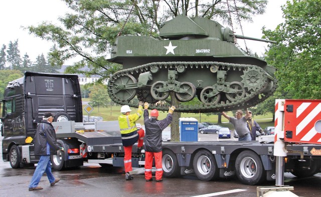Workers load a World War II M-5A1 Stuart Light Tank onto a truck at the former 1st Armored Division ‘Old Ironsides’ Museum in Baumholder, Germany on Aug. 21, 2009. The museum moved numerous tanks, half-tracks, artillery pieces and a building...