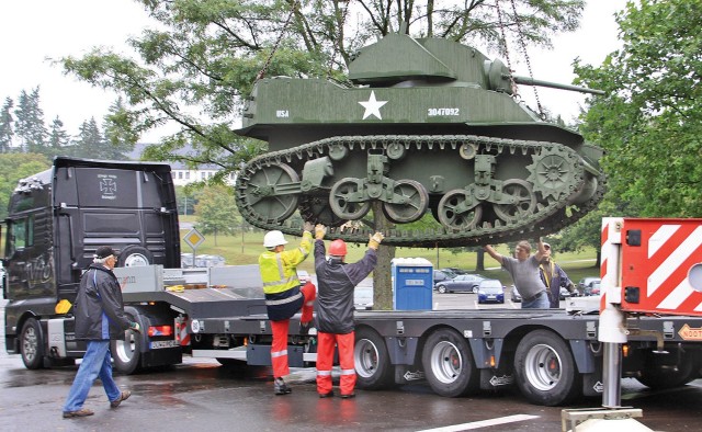 Workers load a World War II M-5A1 Stuart Light Tank onto a truck at the former 1st Armored Division ‘Old Ironsides’ Museum in Baumholder, Germany on Aug. 21, 2009. The museum moved numerous tanks, half-tracks, artillery pieces and a building full of uniforms, weapons and other military paraphernalia as it followed the division to Fort Bliss, Texas, the new home of the 1AD. (U.S. Army photo)