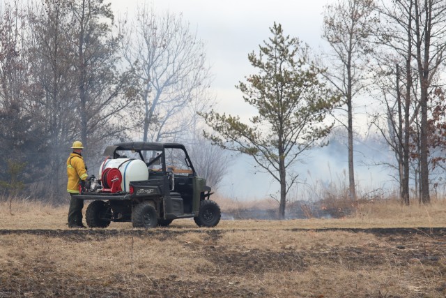 A Fort McCoy, Wis., prescribed burn team member oversees a prescribed burn March 16, 2020, along the railroad tracks on South Post at the installation. The post prescribed burn team includes personnel with the Fort McCoy Directorate of Emergency...