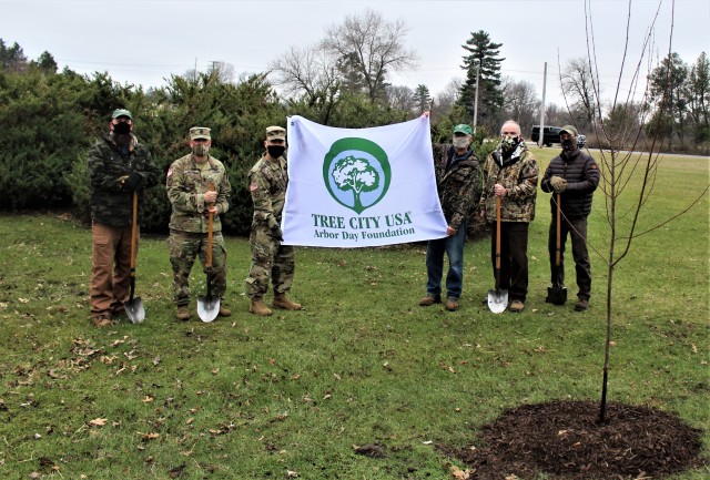 Garrison staff members, all practicing protective measures, stand with the post’s newest Tree City USA flag in front of a newly planted tree during the installation’s 2020 Arbor Day observance April 24, 2020, at Fort McCoy, Wis. For the...