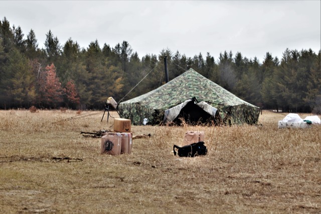 A raised Arctic 10-person tent is shown as students in Cold-Weather Operations Course (CWOC) Class 20-05 prepare to set up a bivouac area during training March 16, 2020, on a North Post training area at Fort McCoy, Wis. CWOC students are trained...