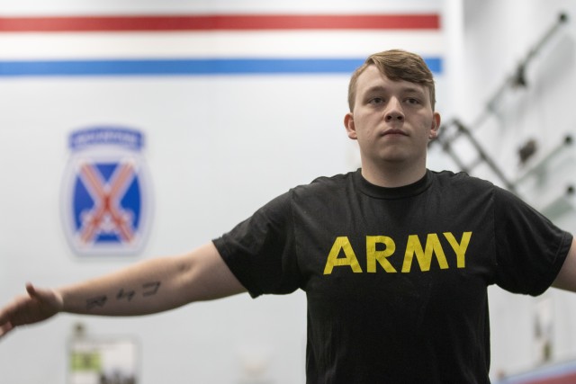 Spc. Brandon Winfield, an air defense battle management systems operator in Headquarters and Headquarters Battalion, 10th Mountain Division (LI), warms up at Monti Physical Fitness center as part of the Unbreakable Warrior Program. (U.S. Army photo by Spc. Gregory Muenchow)