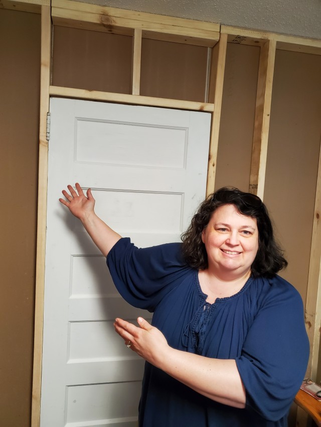 Michelle Larson, engineer, with a door and wall her son built into her home office, located in the family room.