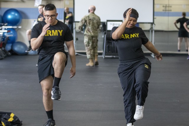 Sgt. Alberto Resendiz, an instructor in the Unbreakable warrior program, and Spc. Kendra Smith, a participant in the program work together through the program&#39;s exercises. (U.S. Army photo by Spc. Gregory Muenchow)