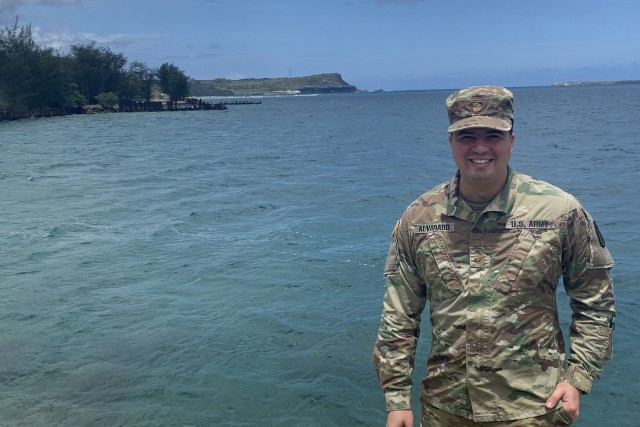 Army Maj. (Dr.) Gadiel Alvarado, infectious diseases physician, poses for a photo in Guam with the USS Theodore Roosevelt (CVN 71) in the background April 18, 2020. Alvarado served as the infectious disease expert for the COVID-19 Public Health...