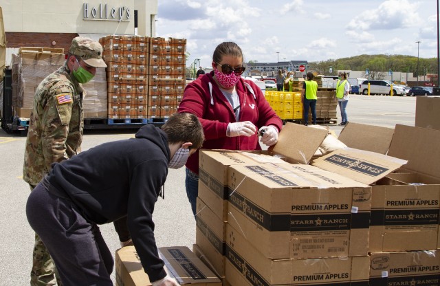 Spc. Justin McAtee, a petroleum supply specialist with Company A, 248th Aviation Support Battalion, Iowa Army National Guard, assists volunteers unloading fresh goods in support of the Hawkeye Area Community Action Program’s mobile food pantry outside Lindale Mall in Cedar Rapids, Iowa, on May 6, 2020. With the help of the Soldiers, HACAP was able to help 2,000 people in need of food assistance within the local community. (U.S. Army National Guard photo by Cpl. Samantha Hircock)