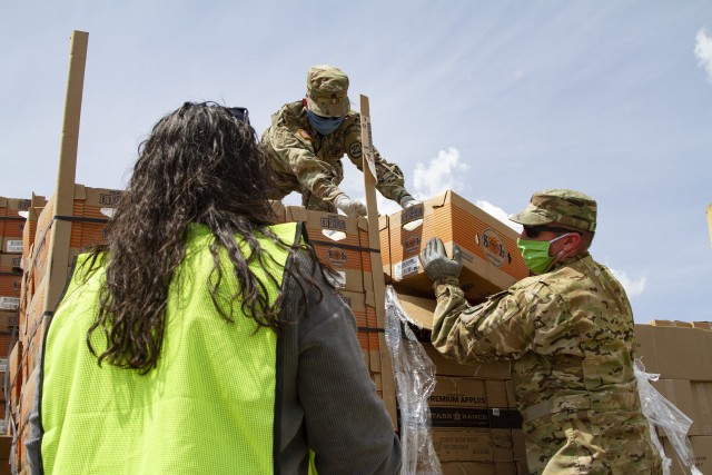 Staff Sgt. Josh Conder and Sgt. Izet Murillo, petroleum supply specialists with Company A, 248th Aviation Support Battalion, Iowa Army National Guard, assist volunteers unloading fresh goods in support of the Hawkeye Area Community Action Program’s mobile food pantry outside Lindale Mall in Cedar Rapids, Iowa, on May 6, 2020. With the help of the Soldiers, HACAP was able to help 2,000 people in need of food assistance within the local community. (U.S. Army National Guard photo by Cpl. Samantha Hircock)