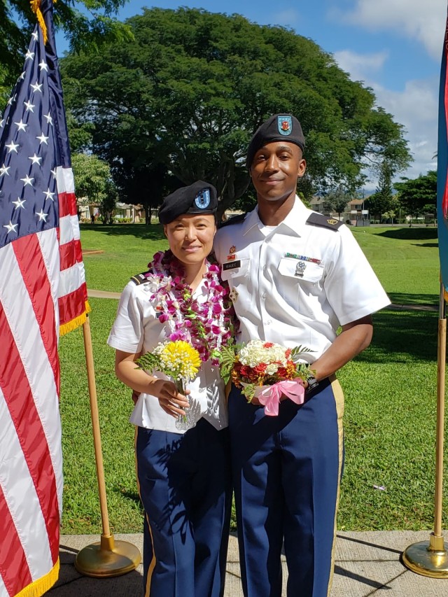 Chief Warrant Officer 2 Meirong Magee and her husband, Staff Sgt. Michael Magee, with Hawaiian leis.  Meirong was one of only four warrant officers selected  for this year&#39;s  Army-level Gen. Douglas MacArthur Leadership Award. Recipients were...