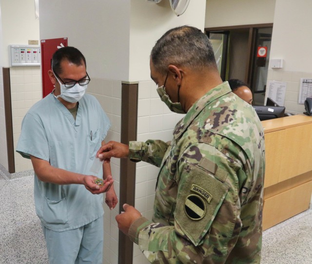 Gen. Michael X. Garrett, commander of U.S. Army Forces Command,recognizes staff at Keller Army Community Hospital at West Point during a tour May 7, 2020. Garrett tours the hospitals COVID-19 ward to learn more about the preparations being made...