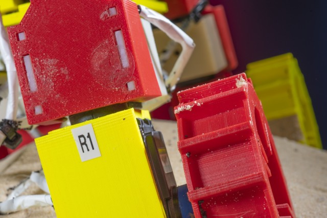 The robot, known as the Mini Rover, climbs a slope by using a design that combines paddling, walking, and wheel spinning motions. This close-up image shows one of the appendages of the Mini Rover. The leg can be raised and lowered and the wheel moved from side to side to move through loose granular surfaces. 