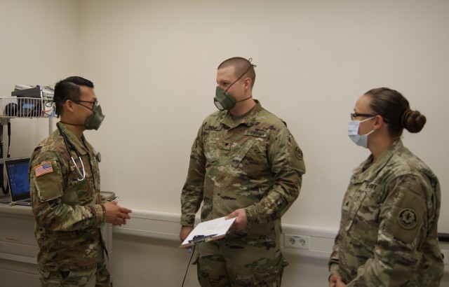 U.S. Army Capt. Trungviet [Joey] Nguyen, regimental nurse, assigned to the 2d Cavalry Regiment, discusses medical training opportunities with his staff members at the Soldier Readiness Program Clinic on Rose Barracks, Germany, May 12, 2020. As the only nurse in the 2d Cavalry Regiment, Nguyen plays an essential role in ensuring medical providers stay proficient in their skills. (U.S. Army photo by Maj. John Ambelang)