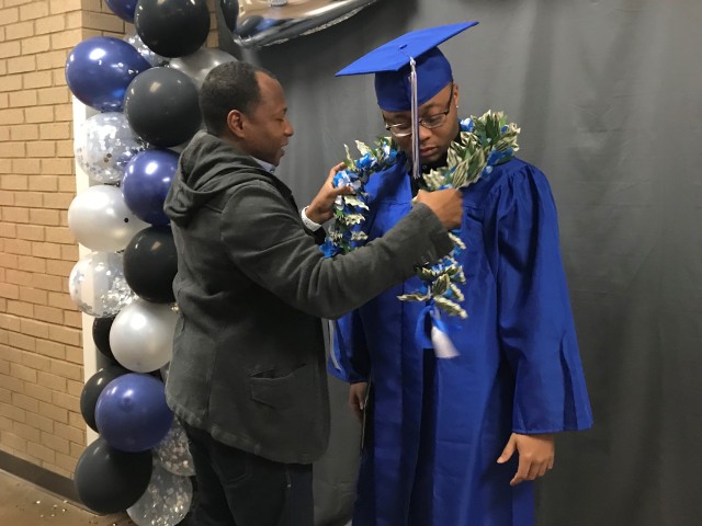 T’ea Valenti, graduating senior, bows her head as her father, Dean Valenti Sr., U.S. Army retiree, moves her tassel for her during the filming of the Fort Campbell High School 2020 Graduation Ceremony May 6 at FCHS. The graduating senior’s...