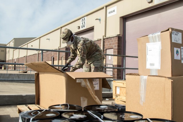Sgt. Charles Sogbo, 62nd Quartermaster Company, 553rd Combat Sustainment Support Battalion, 1st Cavalry Division Sustainment Brigade, receives parts at the Wagonmaster supply support activity warehouse, Fort Hood, Texas, April 29, 2020. (U.S. Army Photo by Sgt. Calab Franklin)