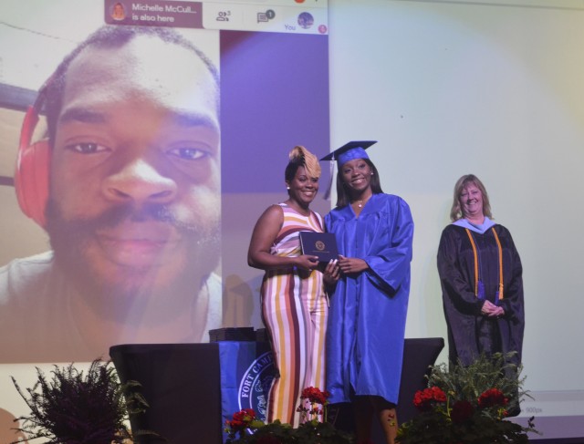 Anijia Black, Fort Campbell High School graduating senior, poses with her mom, Tcipporah Jean-Juste, as FCHS Principal Kimberly Butts looks on during the filming of the FCHS 2020 Graduation Ceremony May 6 at FCHS. Staff Sergeant Jonah Jean-Juste,...
