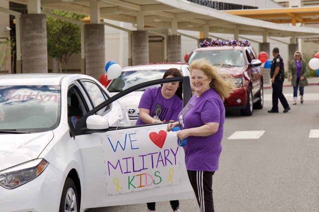 Freedom Elementary School teachers and administrators put  finishing touches on their cars before they begin the parade route through Fort Sill neighborhoods May 8, 2020.  School staff and DES employees in 50 cars and emergency services vehicles...