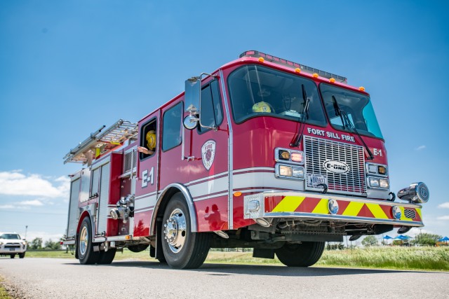 Below, Fort Sill Fire Engine No. 1’s crew drives in the parade May 8, 2020, at Fort Sill.