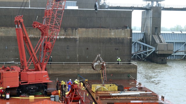 U.S. Army Corps of Engineers, Tulsa District maintenance crews working on the McClellan Kerr Arkansas River Navigation System, clean debris from the downstream side of the Webbers Falls powerhouse May 12, 2020.  Removing the debris helps ensure...