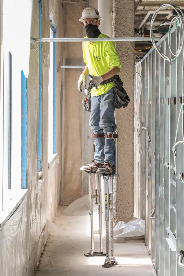 contractor maneuvers on stilts to install dry wall May 14, at what will be an alternate care facility in Kalispell, Mont. The state of Montana requested FEMA to task the U.S. Army Corps of Engineers, Omaha District, to build the ACF on the vacant,...