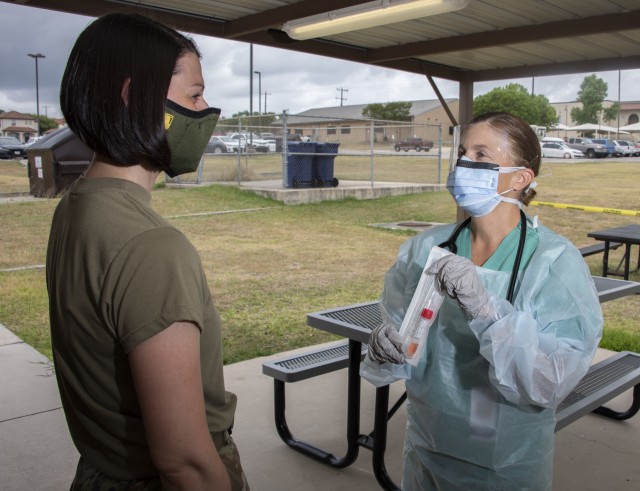 U.S. Army Col. April Critelli, physician’s assistant, screens a patient for COVID-19 at the McWethy Troop Medical Clinic, Fort Sam Houston, Texas, May 13, 2019. Critelli is the first medical Soldier to return to active duty from retirement during the COVID-19 crisis.