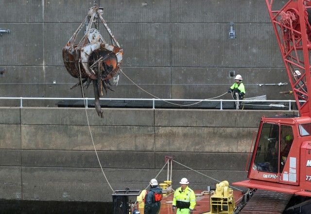 U.S. Army Corps of Engineers, Tulsa District maintenance crews working on the McClellan Kerr Arkansas River Navigation System, clean debris from the downstream side of the Webbers Falls powerhouse May 12, 2020.  Removing the debris helps ensure...