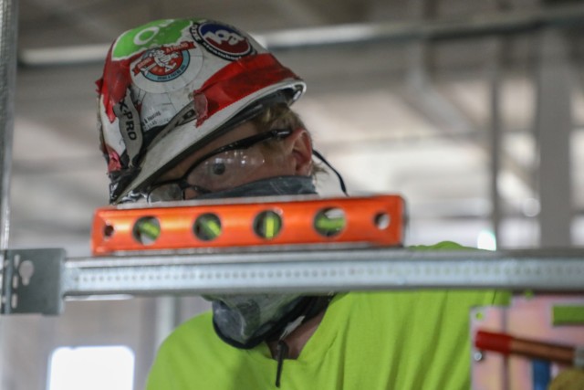 A contractor eyes the levelness of his work May 11, on the framework for the pods of what will be an alternate care facility in the fight against the Covid-19 pandemic in Kalispell, Mont. The state of Montana requested FEMA to task the U.S. Army...