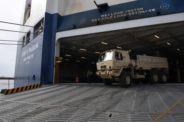 1061 – A contract worker backs a vehicle onto the M/V Liberty Passion at Naval Weapons Station, Joint Base Charleston in Support of DEFENDER-Europe 20 March 10, 2020. Exercises like this ensure the U.S. military will be able to dynamically project force to set the theater by mobilizing and deploying forces, sustaining them in a crisis and redeploying them when their mission is complete. 