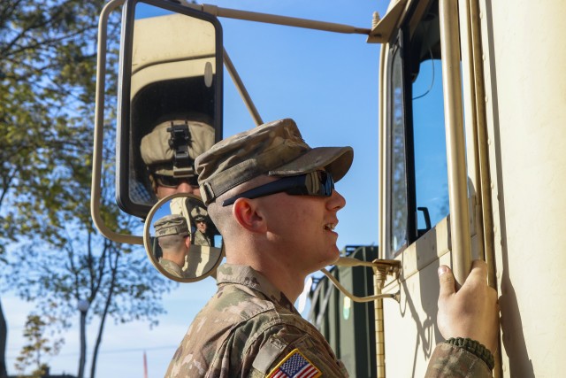 U.S. Army Reserve Spc. Chance Vire, a truck driver from Springfield, Illinois (foreground), talks with fellow truck driver Sgt. John Taylor (in the mirror) from the step of a M915 tractor trailer before the start of a ring mount mission April 28 at Powidz Air Base, Powidz, Poland. Vire and his fellow Soldiers from the 724th Transportation Company out of Bartonville, Illinois, are deployed to Poland where they run fueling and supply missions to base camps throughout the country. (U.S. Army Reserve photo by Master Sgt. Ryan C. Matson, 652nd Regional Support Group)