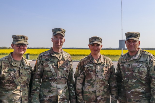 From left, U.S. Army Reserve Spc. Dalton Medley, Staff Sgt. James Lowe, Spc. Chance Vire, and Sgt. John Taylor, all truck drivers with the 724th Transportation Company out of Bartonville, Illinois, pose for a photo during a roadside break from delivering maintenance supplies from Powidz Air Base to Drawsko Pomorskie Training Area April 28. (U.S. Army Reserve photo by Master Sgt. Ryan C. Matson, 652nd Regional Support Group)