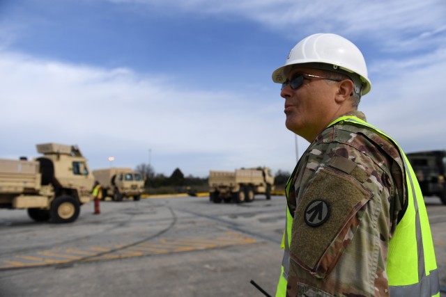 Chief Warrant Officer 3 Eric Brooker, 841st Transportation Battalion DDST chief mobility warrant officer,  monitors vehicles as they board the M/V Liberty Passion at Naval Weapons Station, Joint Base Charleston in Support of DEFENDER-Europe 20 March 10, 2020. Exercises like this ensure the U.S. military will be able to dynamically project force to set the theater by mobilizing and deploying forces, sustaining them in a crisis and redeploying them when their mission is complete.  