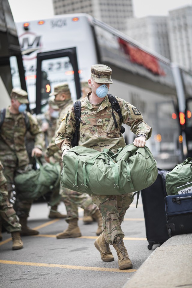 Buses carrying Soldiers from Urban Augmentation Medical Task Force 801-2 arrive at the Marriot Hotel Renaissance Center in Detroit, Michigan, April 10th, 2020. U.S. Northern Command, through U.S. Army North, is providing military support to the Federal Emergency Management Agency to help communities in need. 
