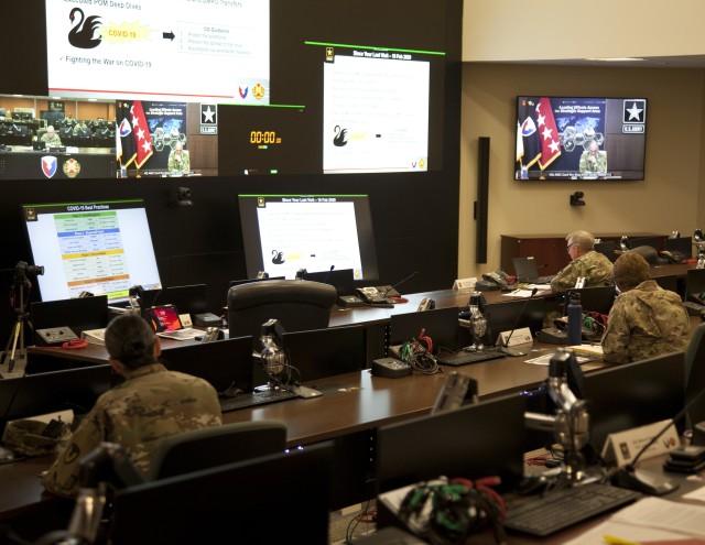 Gen. Gustave Perna (displayed on two screens), commanding general, U.S. Army Materiel Command, dials in virtually for his major subordinate command update with U.S. Army Installation Management Command and its commander, Lt. Gen. Douglas Gabram (front right) May 18 at Fort Sam Houston, Texas. Perna conducts these MSC updates quarterly as a "conversation between commanders" and to execute mission command of AMC's 11 major subordinate commands.