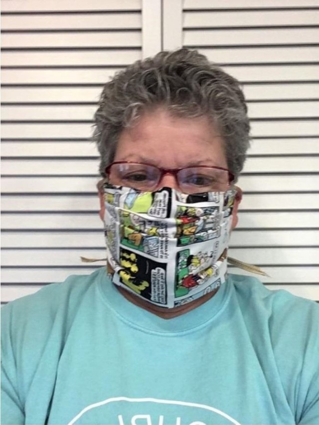 Marie Cochran poses with one of her handmade face masks. She used her quilting skills to make hundreds of face masks for others as protection from COVID-19. Cochran is a retired Army lieutenant colonel and nurse. She currently serves as a logistics management specialist at the U.S. Army Medical Materiel Development Activity's Medical Modernization Product Management Office. (Photo by Marie Cochran.)